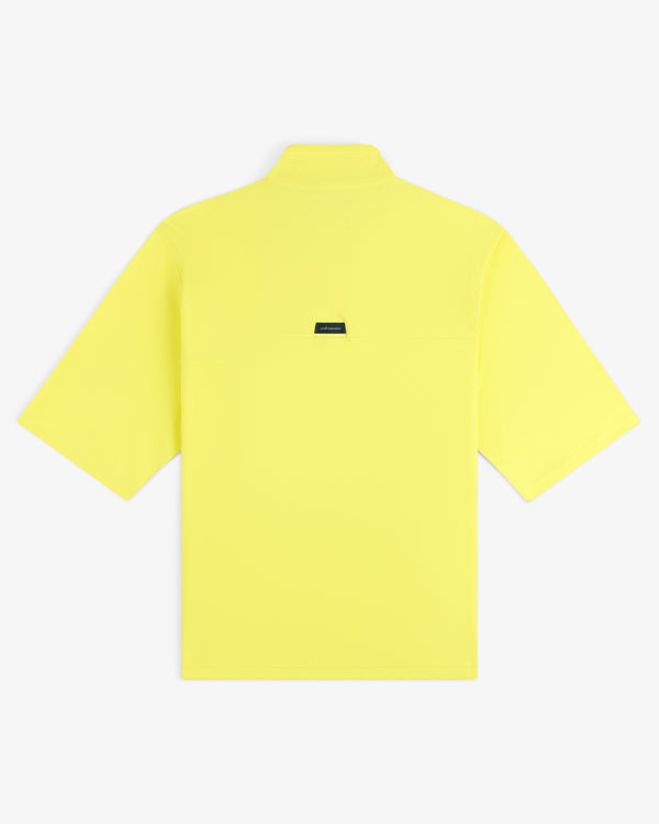 Back view of the ALD Golf Quarter Zip Pullover in bright yellow with a small black rectangular label at the center.