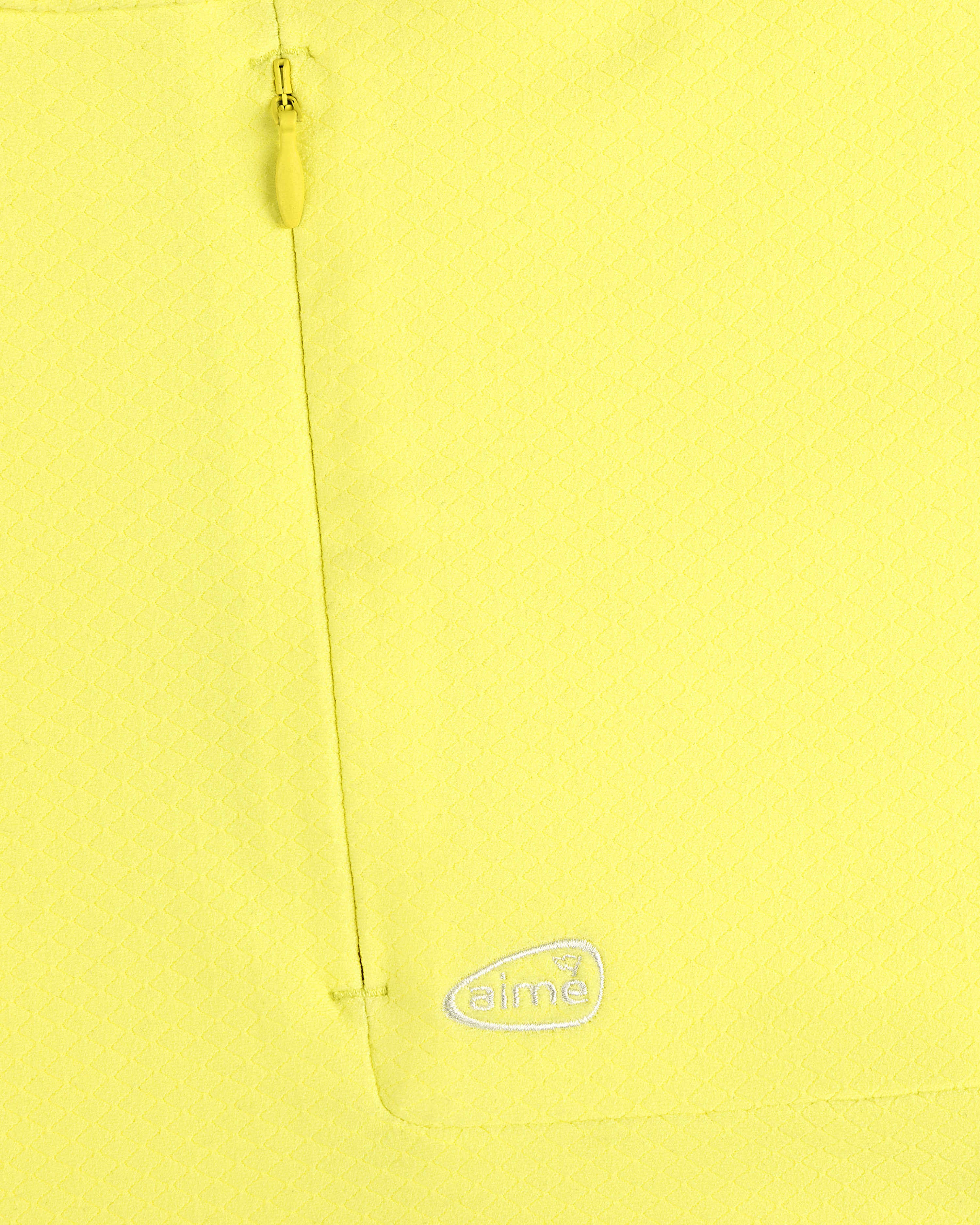 Close-up of ALD Golf Quarter Zip Pullover in yellow with textured fabric, zip pocket, and white aimé logo embroidery.