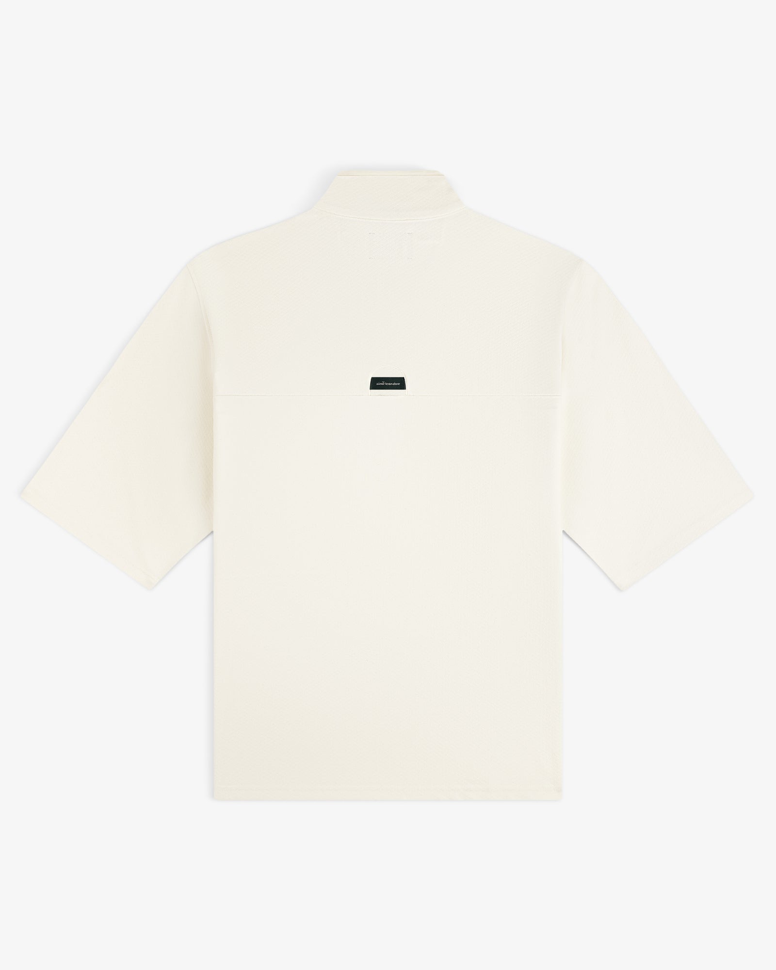 Back view of the ALD Golf Quarter Zip Pullover in off-white, featuring a small black rectangular label at the center.