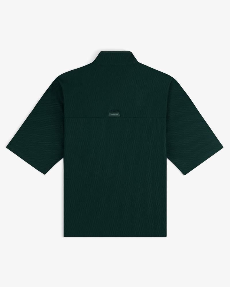 Dark green ALD Golf Quarter Zip Pullover laid flat, back view, featuring a small rectangular label below the collar.