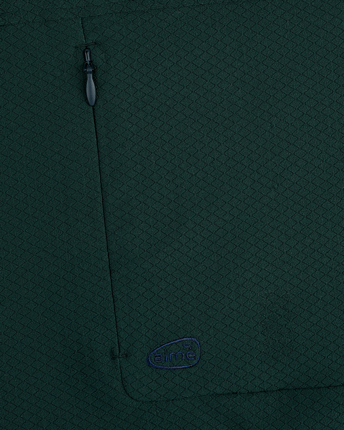 Close-up of dark green ALD Golf Quarter Zip Pullover with zipper pocket and small blue aimé embroidered logo.