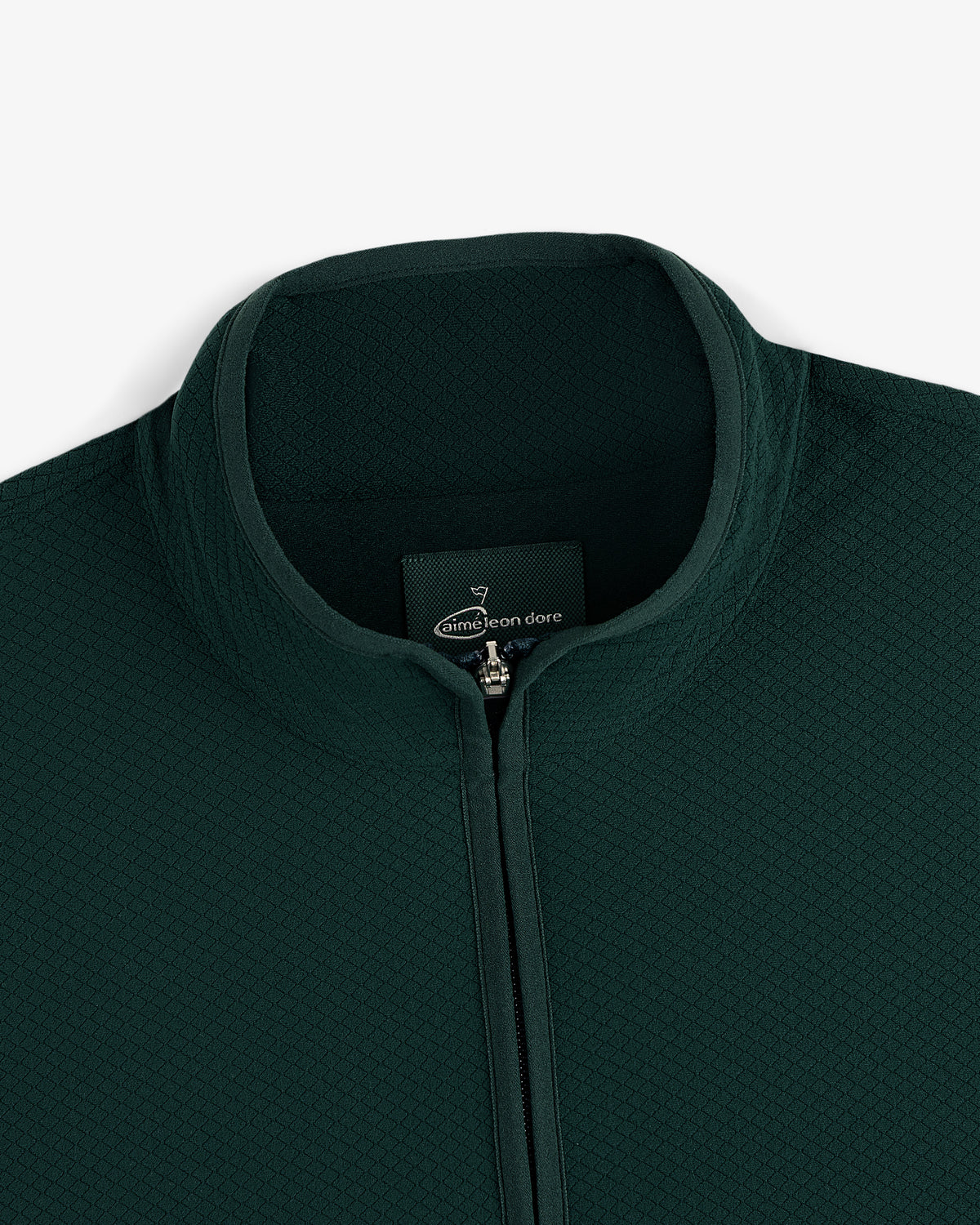 Close-up of the ALD Golf Quarter Zip Pullover in dark green with textured fabric and a stand collar.