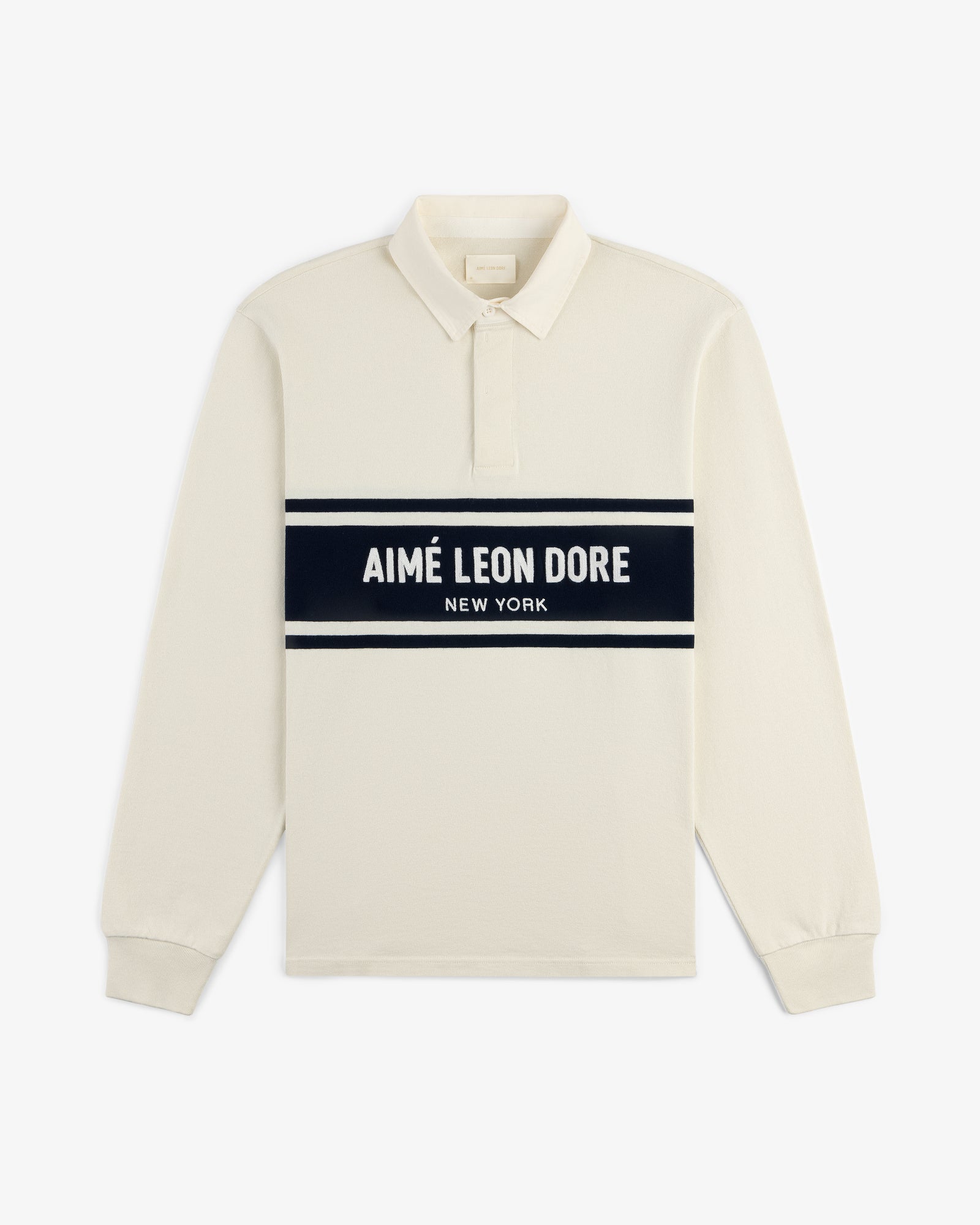 Chest Stripe Logo Rugby: cream long-sleeve polo with AIMÉ LEON DORE NEW YORK on a navy chest stripe.