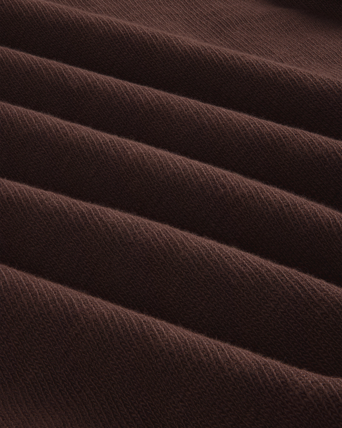 Close-up of folded, ribbed brown Long-Sleeve Slub Football Tee with a soft texture and diagonal lines.