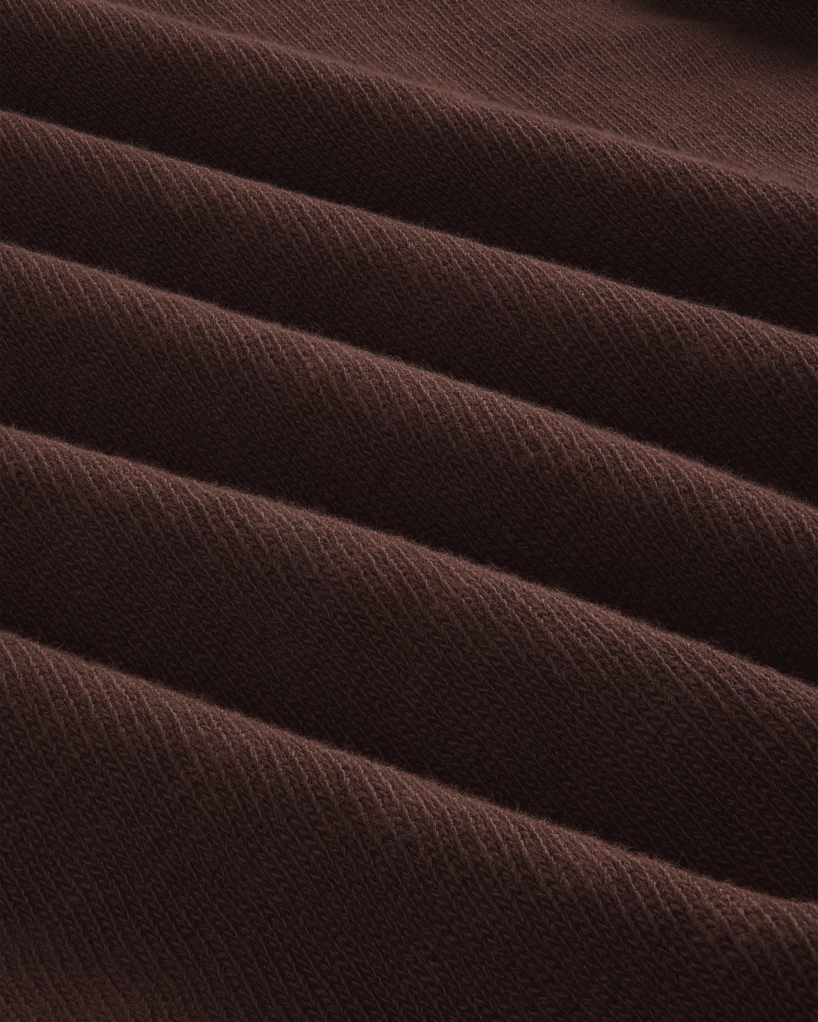 Close-up of folded, ribbed brown Long-Sleeve Slub Football Tee with a soft texture and diagonal lines.