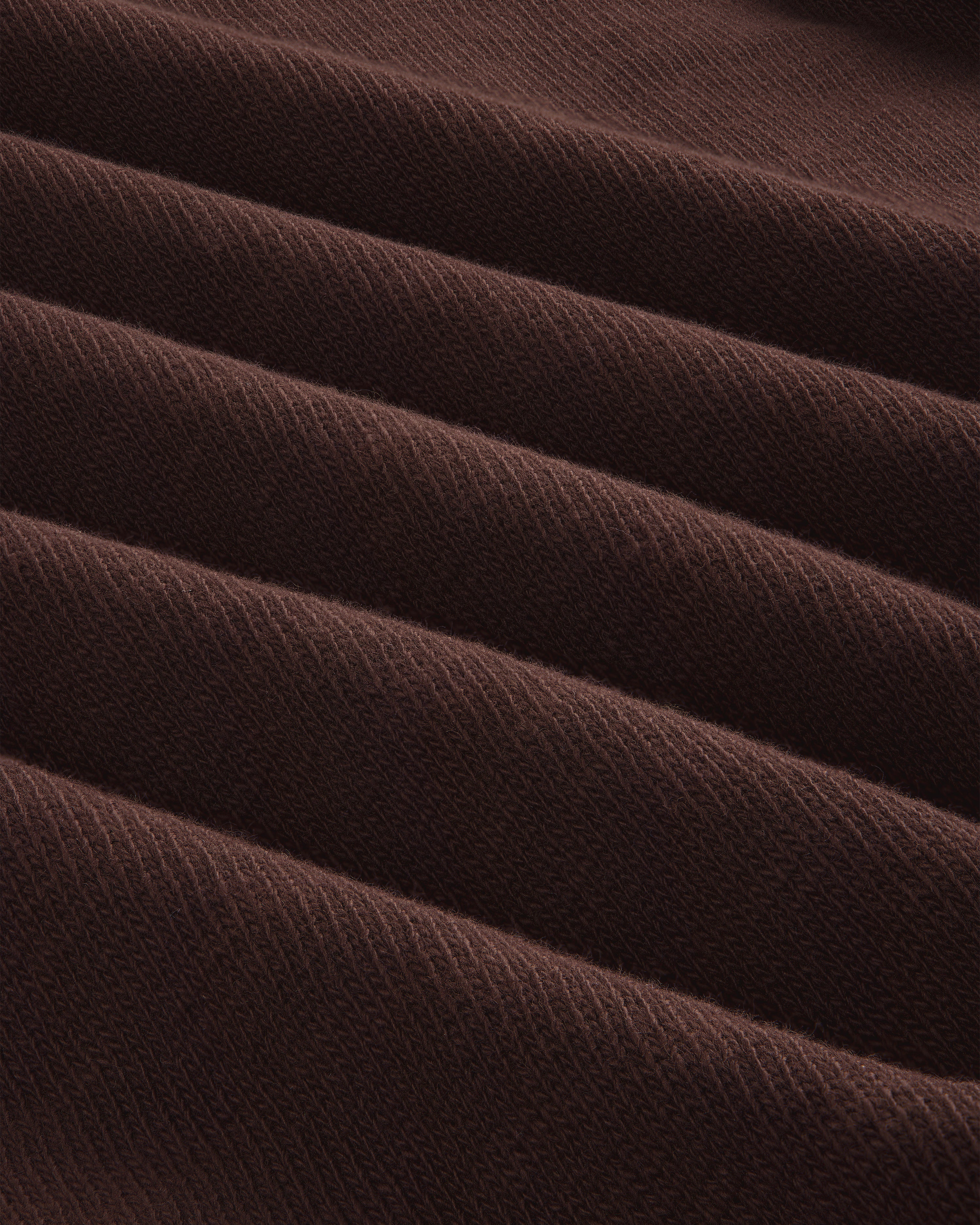 Close-up of folded, ribbed brown Long-Sleeve Slub Football Tee with a soft texture and diagonal lines.