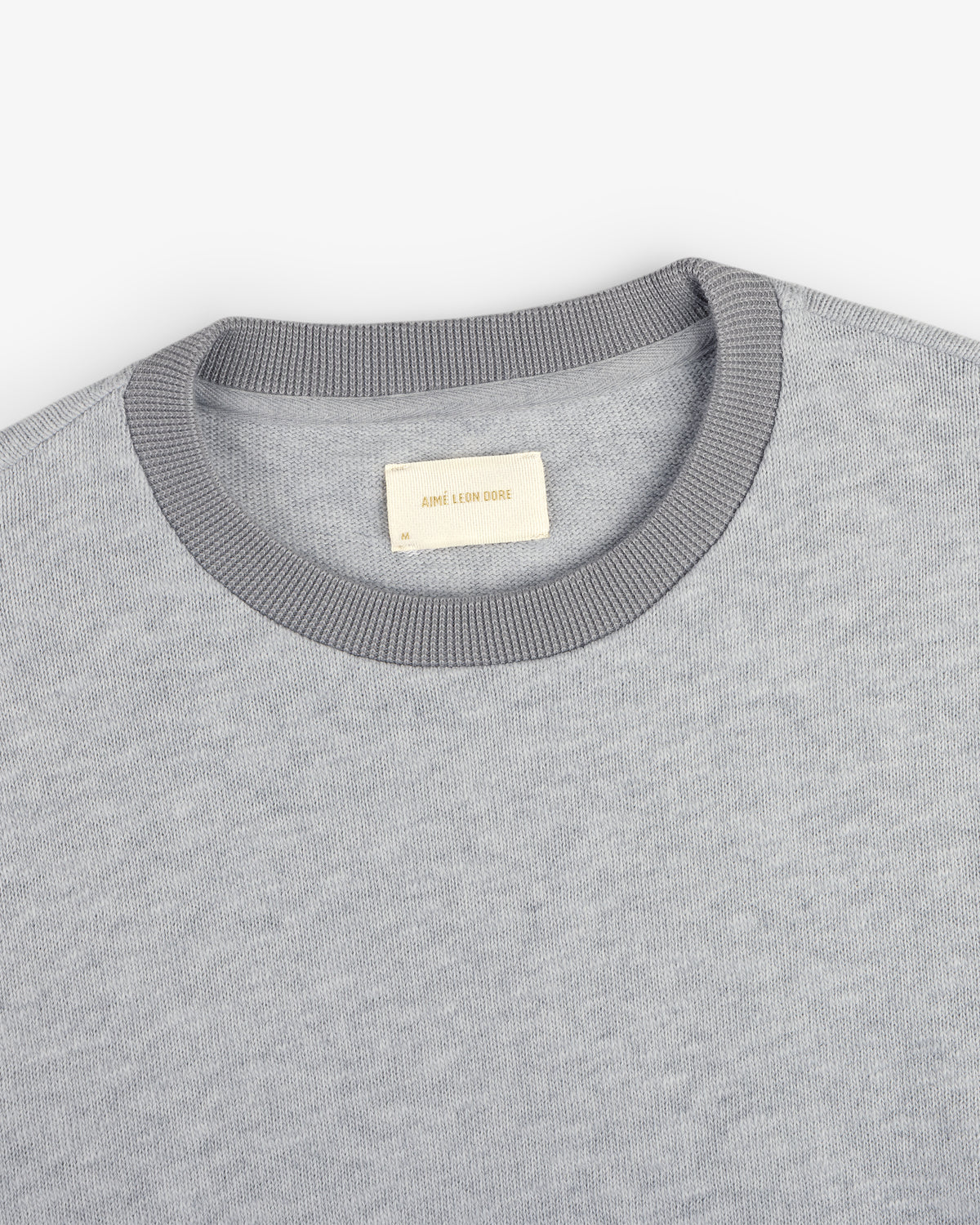 Light gray Long-Sleeve Slub Football Tee with a dark gray collar and white AIMÉ LEON DORE label.