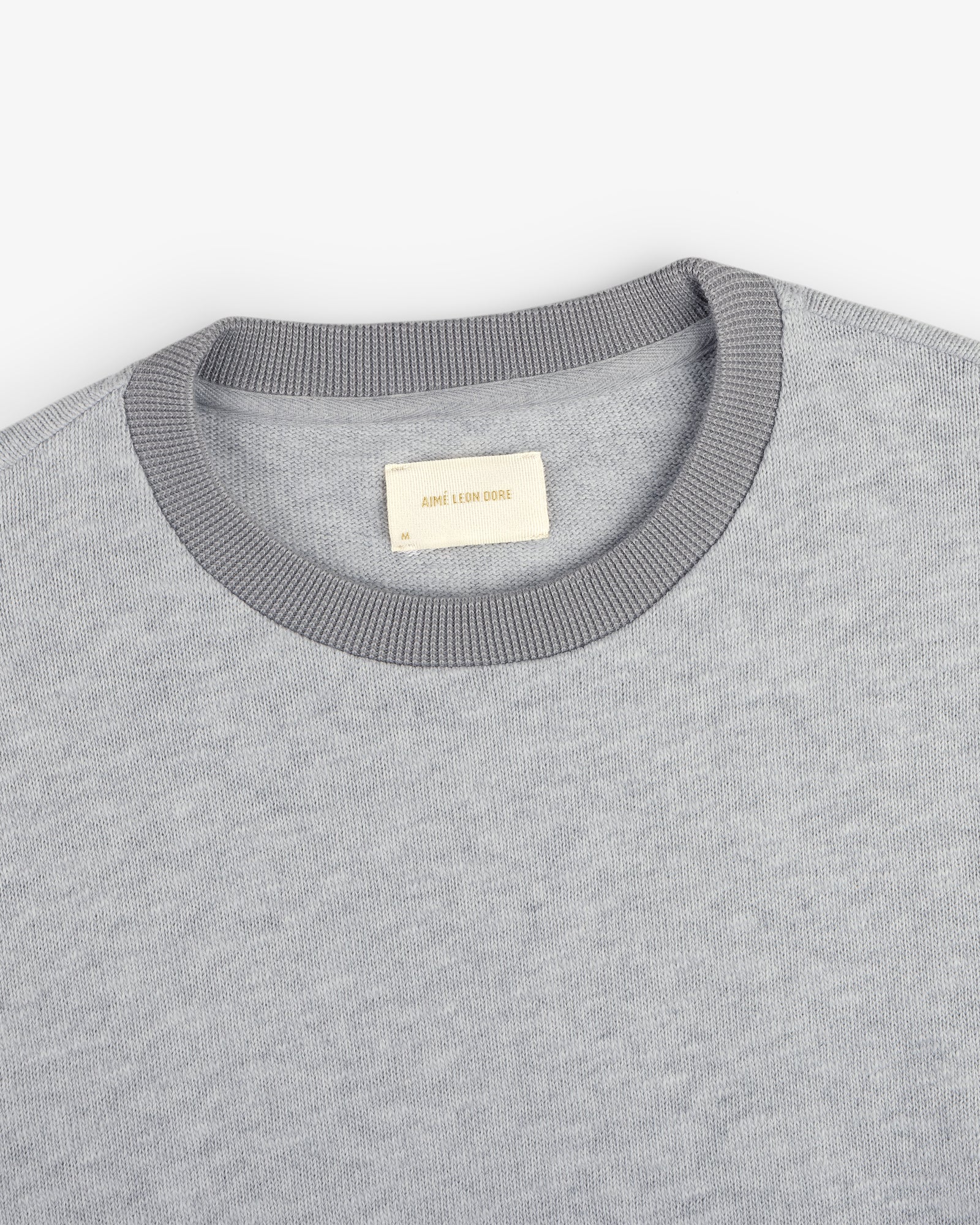 Light gray Long-Sleeve Slub Football Tee with a dark gray collar and white AIMÉ LEON DORE label.
