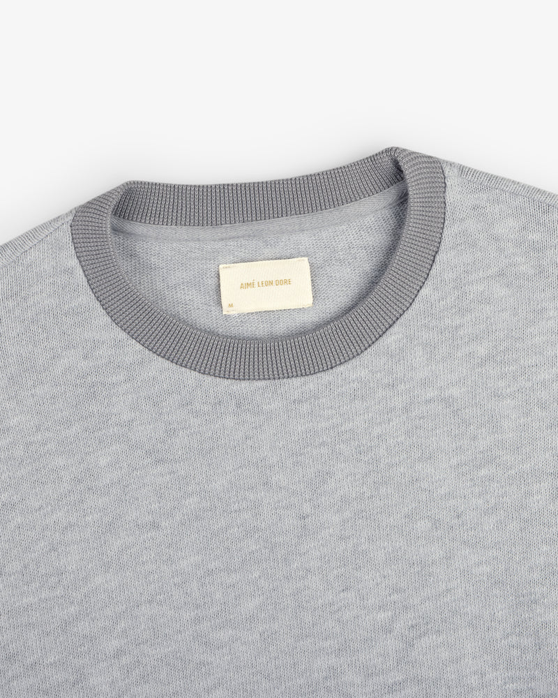 Light gray Long-Sleeve Slub Football Tee with a dark gray collar and white AIMÉ LEON DORE label.