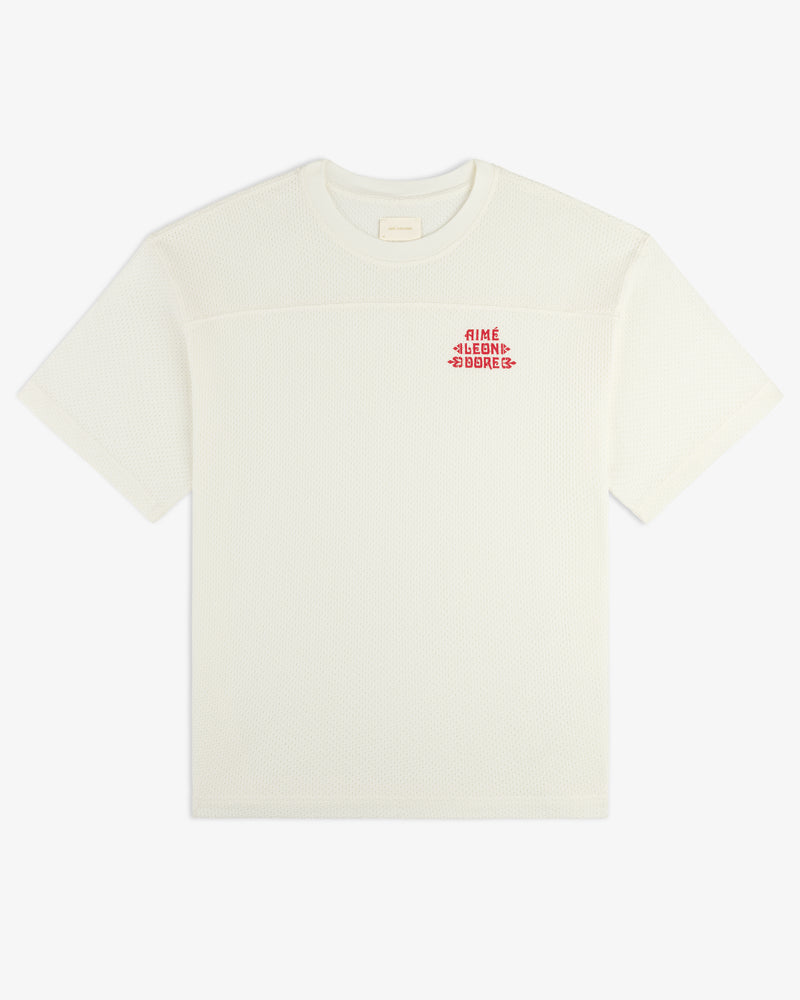 White Pointelle Stacked Logo Tee with short sleeves and small red text on the left chest.