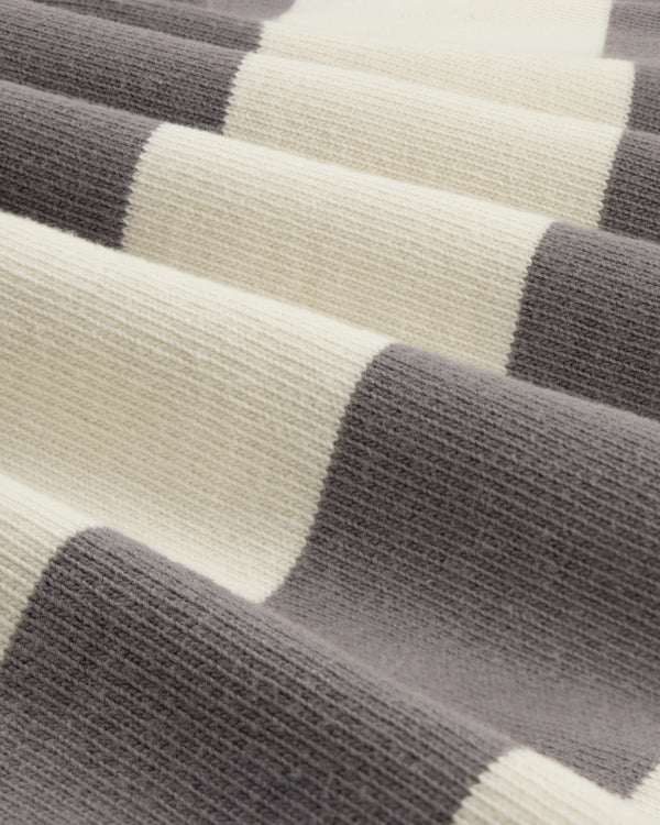 Close-up of Striped Crest Rugby fabric, featuring soft, wavy folds and wide cream and gray horizontal stripes.