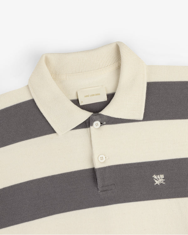 Cream and gray Striped Crest Rugby with collar, two buttons, and embroidered chest logo.