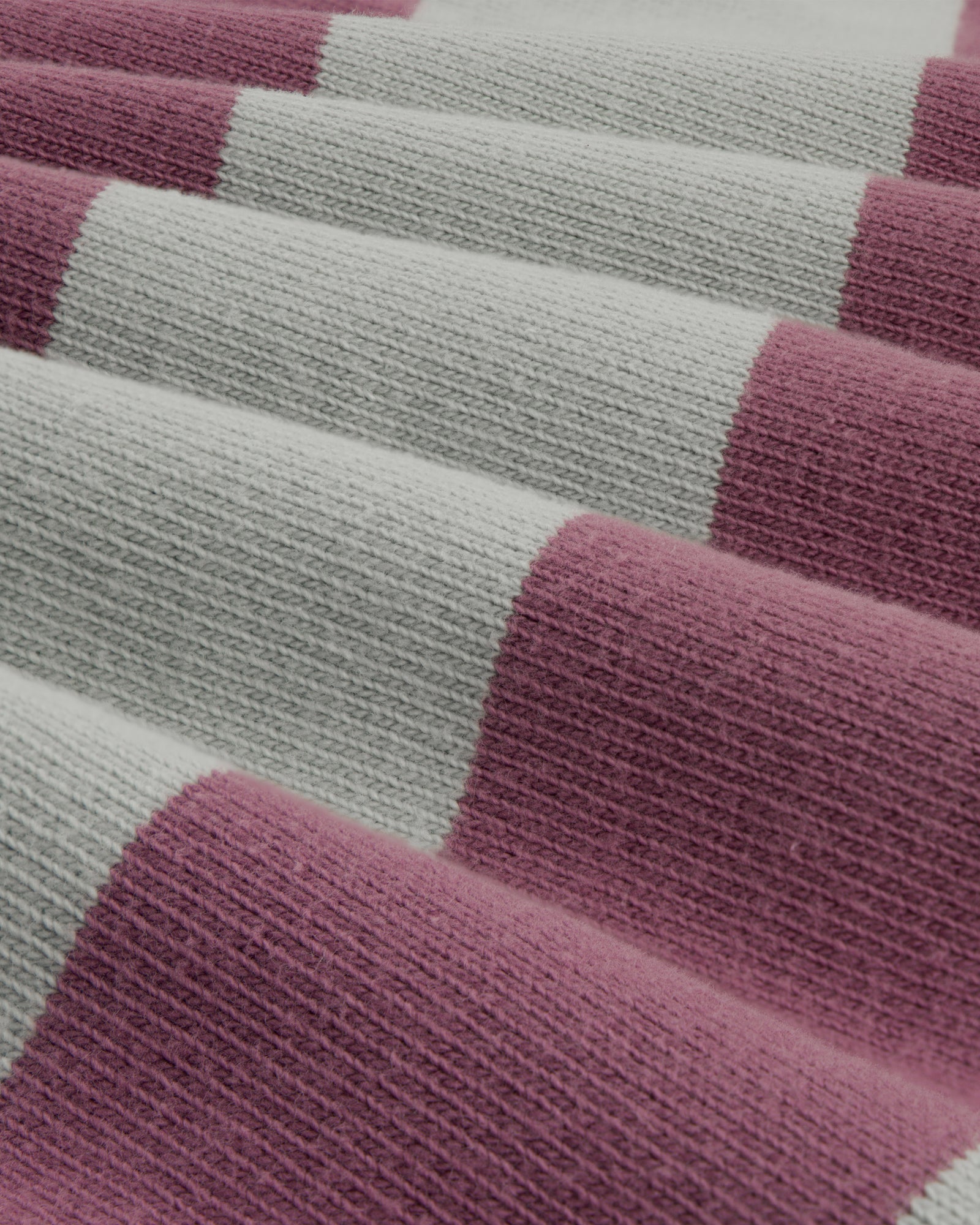 Close-up of Striped Crest Rugby fabric featuring wide pink and light gray horizontal stripes.