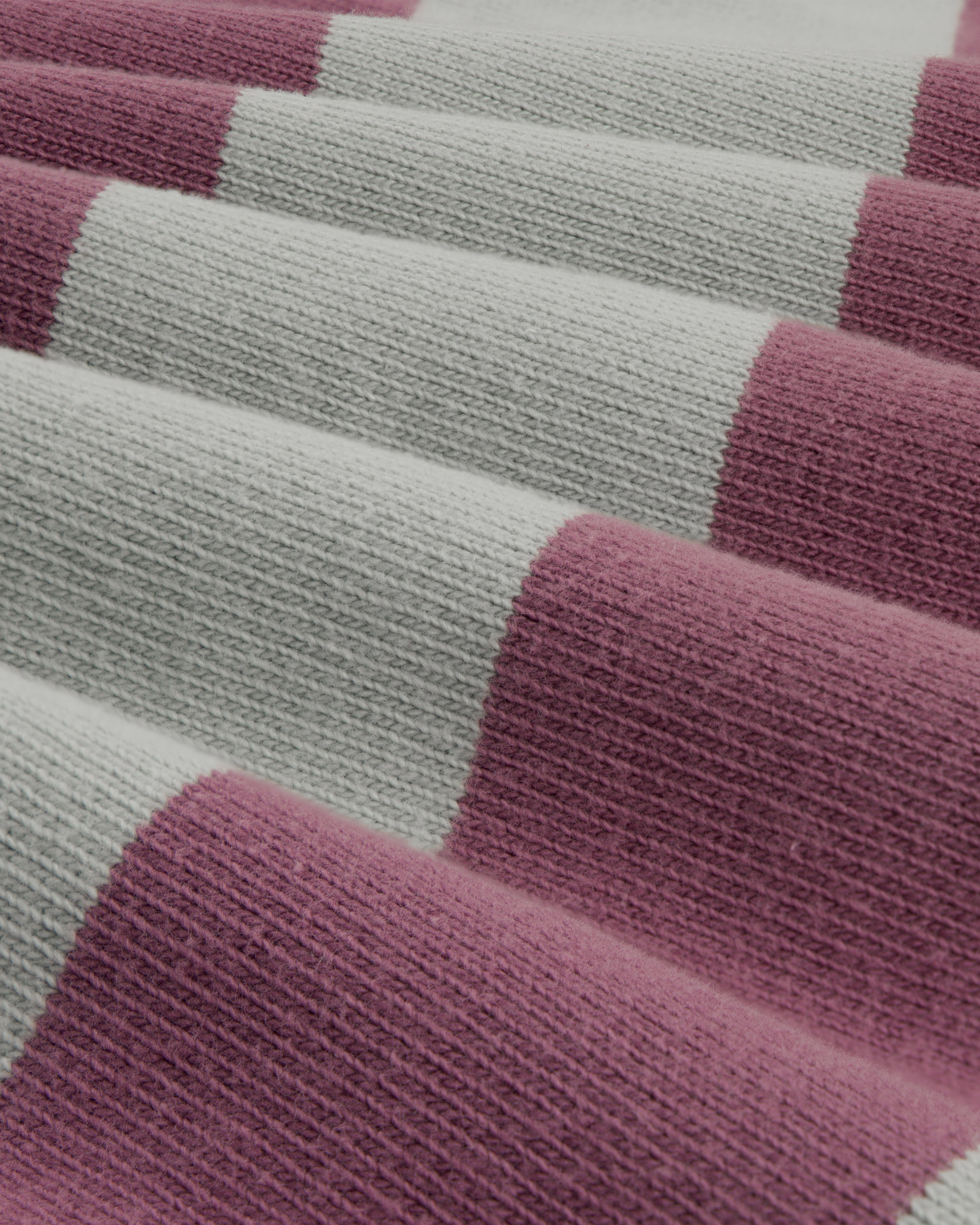 Close-up of Striped Crest Rugby fabric featuring wide pink and light gray horizontal stripes.
