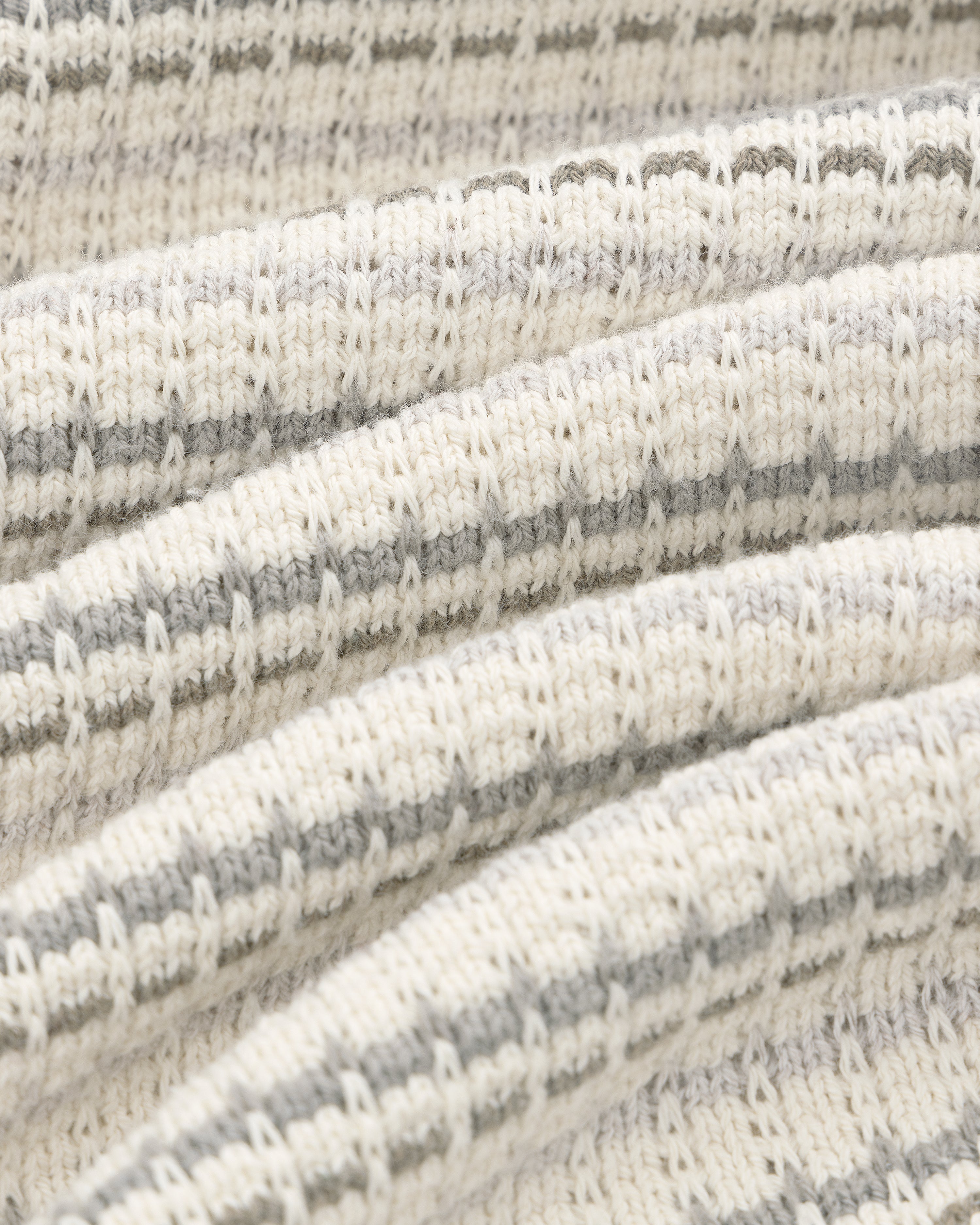 Close-up of the Jacquard Striped Tee's ribbed knit fabric with cream and light gray horizontal stripes in detail.