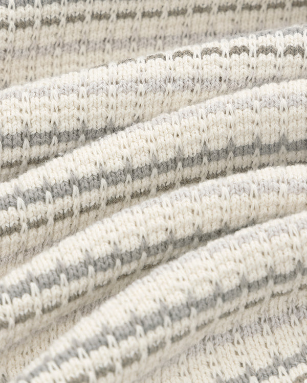 Close-up of the Jacquard Striped Tee's ribbed knit fabric with cream and light gray horizontal stripes in detail.