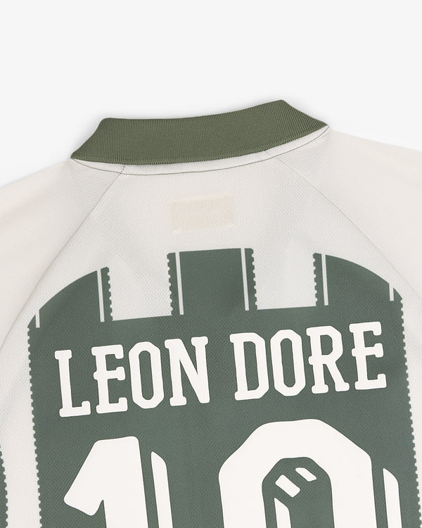Back of the Aimé Cup Soccer Jersey in cream and green with LEON DORE and number 10 in large block letters.