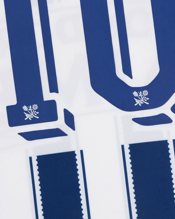 Close-up of the Aimé Cup Soccer Jersey, blue and white stripes, number 10, with small flower designs below the digits.