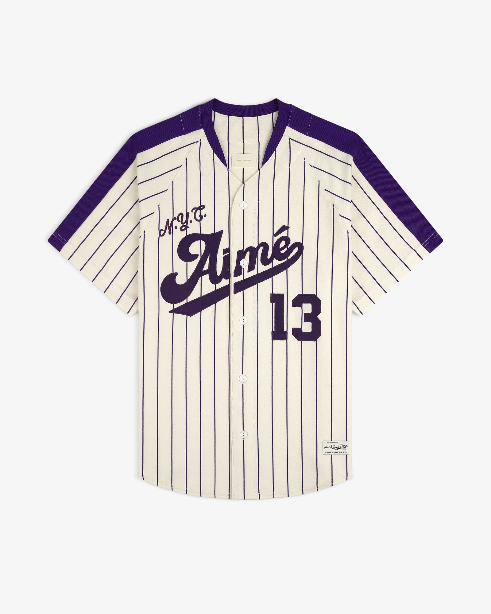 Aimé Baseball Jersey: Ivory with navy pinstripes, 13, Aimé script, and purple shoulders and trim.