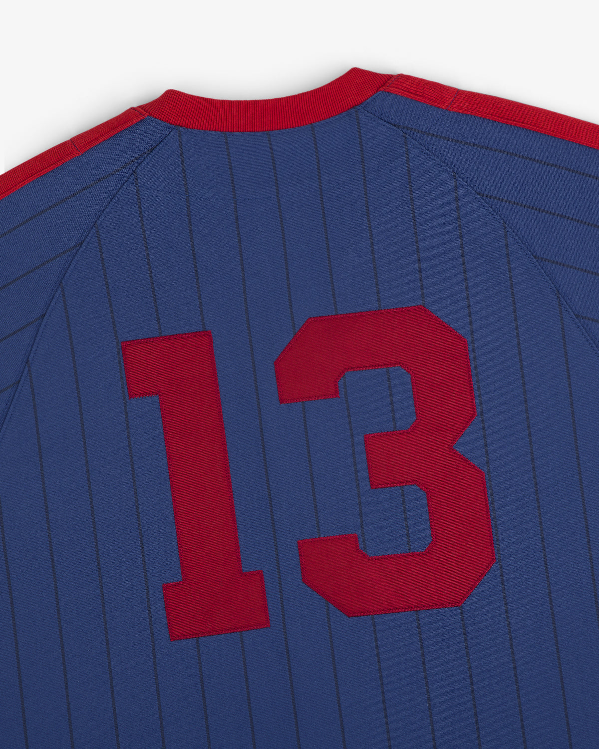 Aimé Baseball Jersey: Blue with thin stripes, red collar and shoulders, large red 13 on the back.