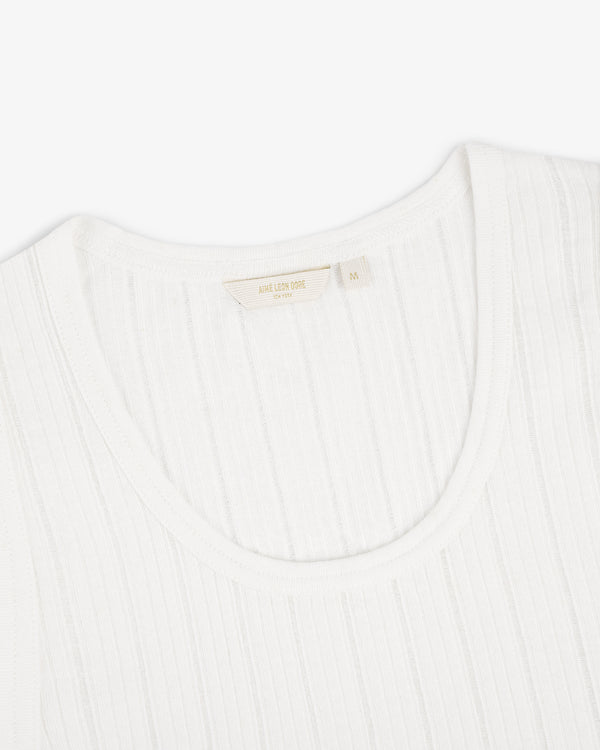 Close-up of a white Drop Needle Tank Top with a ribbed crew neck and visible tag on a plain white background.