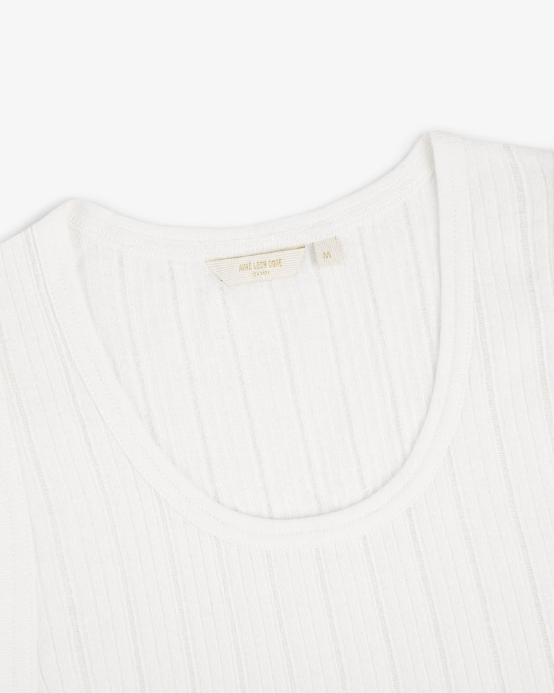 Close-up of a white Drop Needle Tank Top with a ribbed crew neck and visible tag on a plain white background.