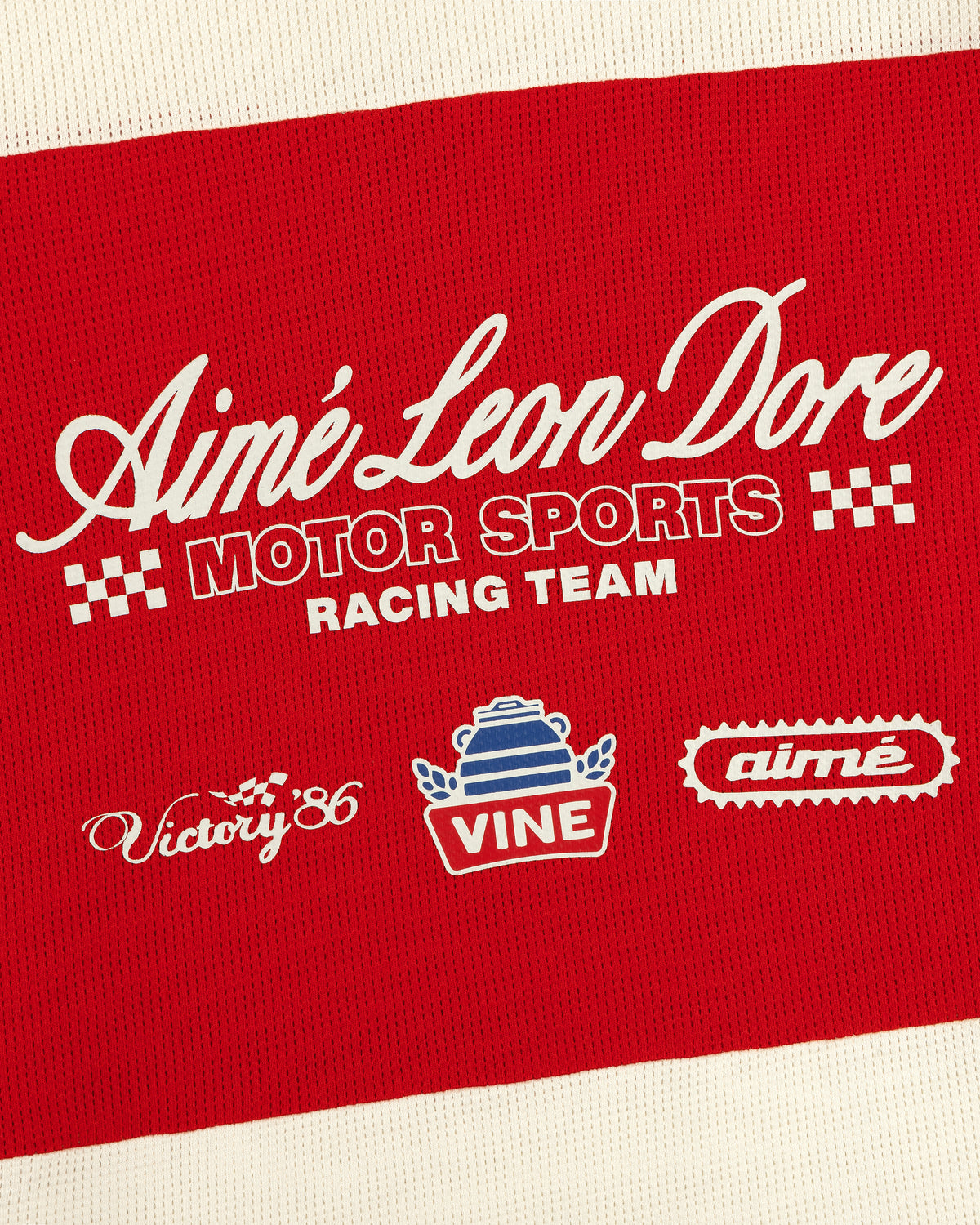 Red and white Aimé Leon Dore Long-Sleeve Mesh Enduro Tee with Motor Sports Racing Team and racing logos.