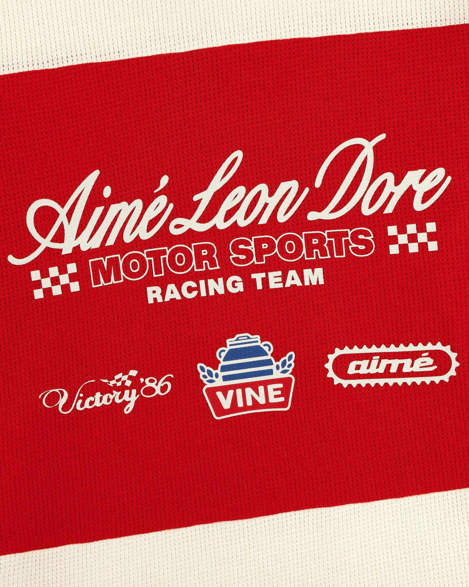 Red and white Aimé Leon Dore Long-Sleeve Mesh Enduro Tee with Motor Sports Racing Team and racing logos.