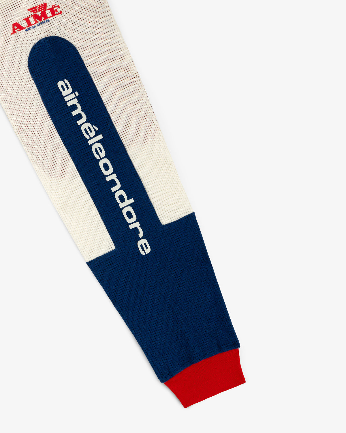 Close-up of a blue and cream Long-Sleeve Mesh Enduro Tee sleeve with red cuff on a white background.