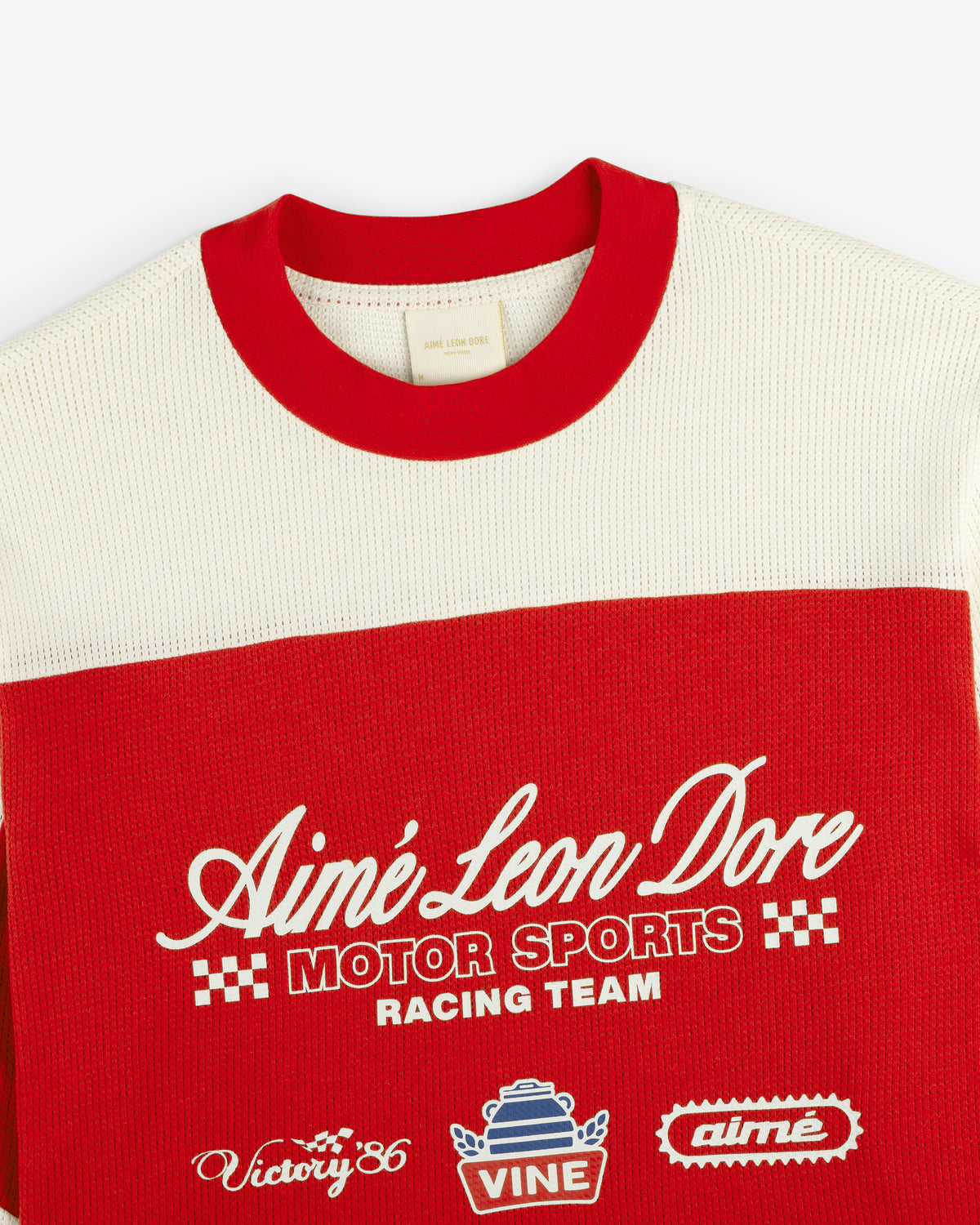 Red and cream Long-Sleeve Mesh Enduro Tee by Aimé Leon Dore with embroidered logos and checkered front accents.