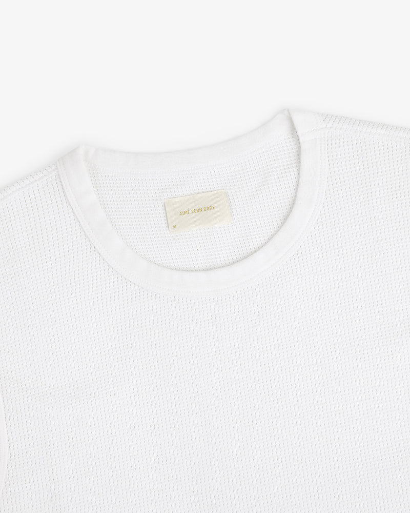 Mesh Muscle Tank shown on a white background with a beige label sewn inside the collar.