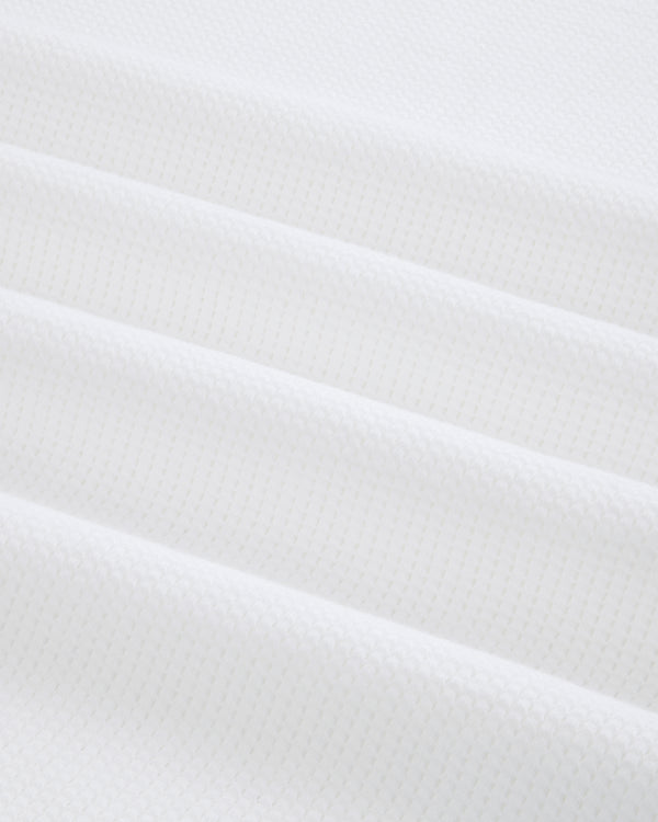 Close-up of white Mesh Muscle Tank fabric with soft, evenly spaced diagonal folds.