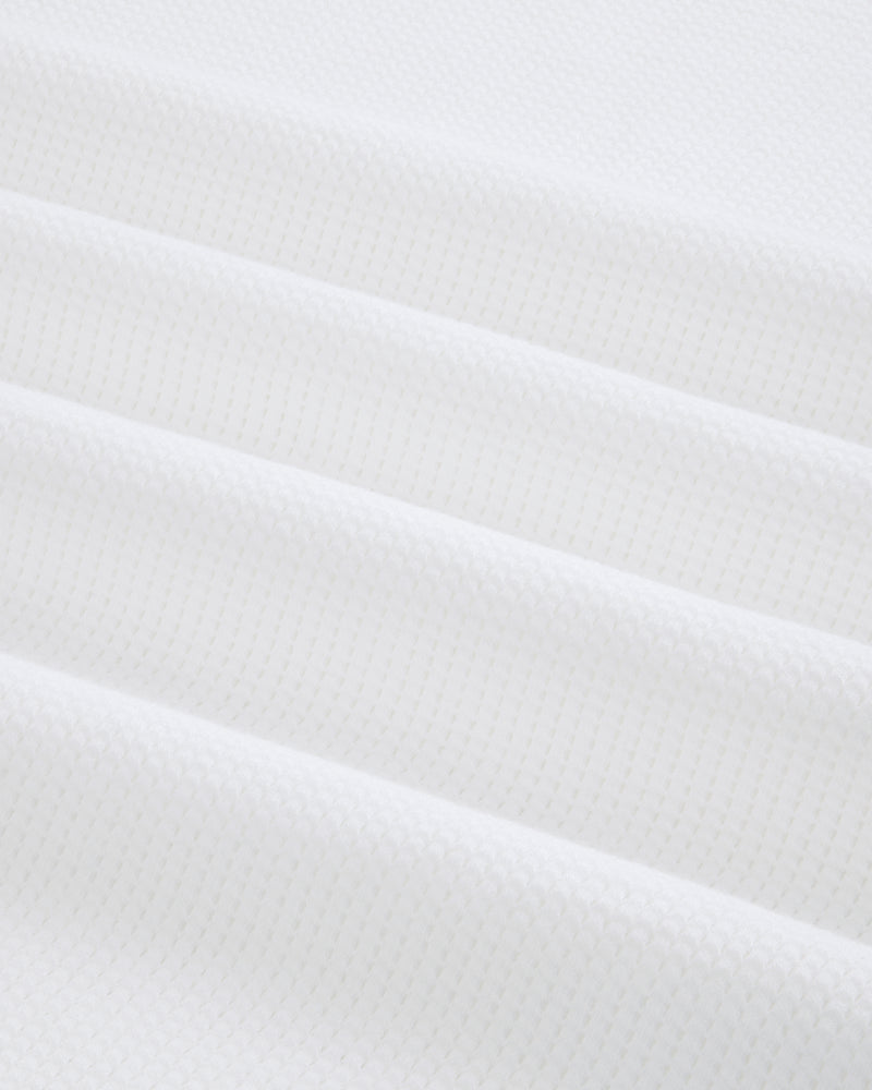 Close-up of white Mesh Muscle Tank fabric with soft, evenly spaced diagonal folds.
