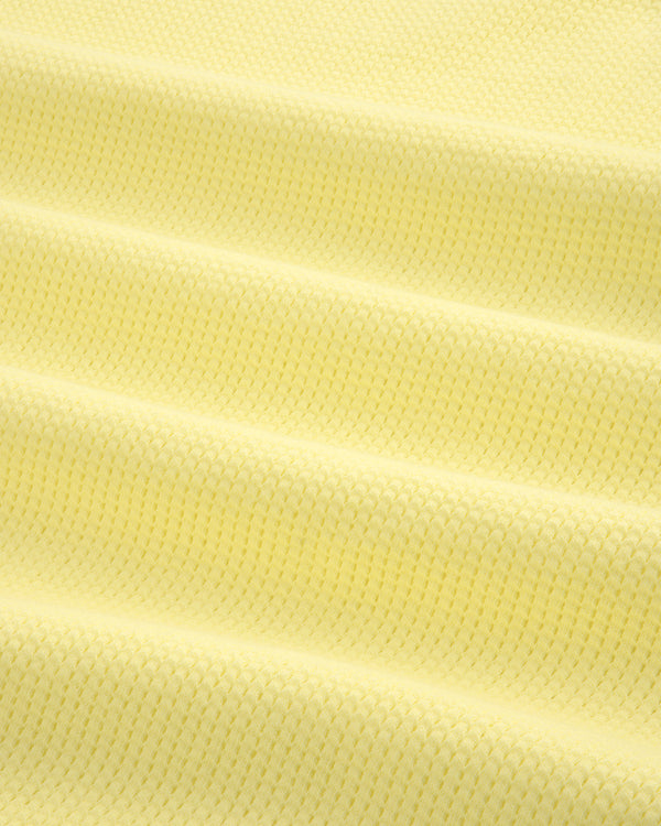 Close-up of pale yellow Mesh Muscle Tank fabric featuring evenly spaced horizontal raised ridges.