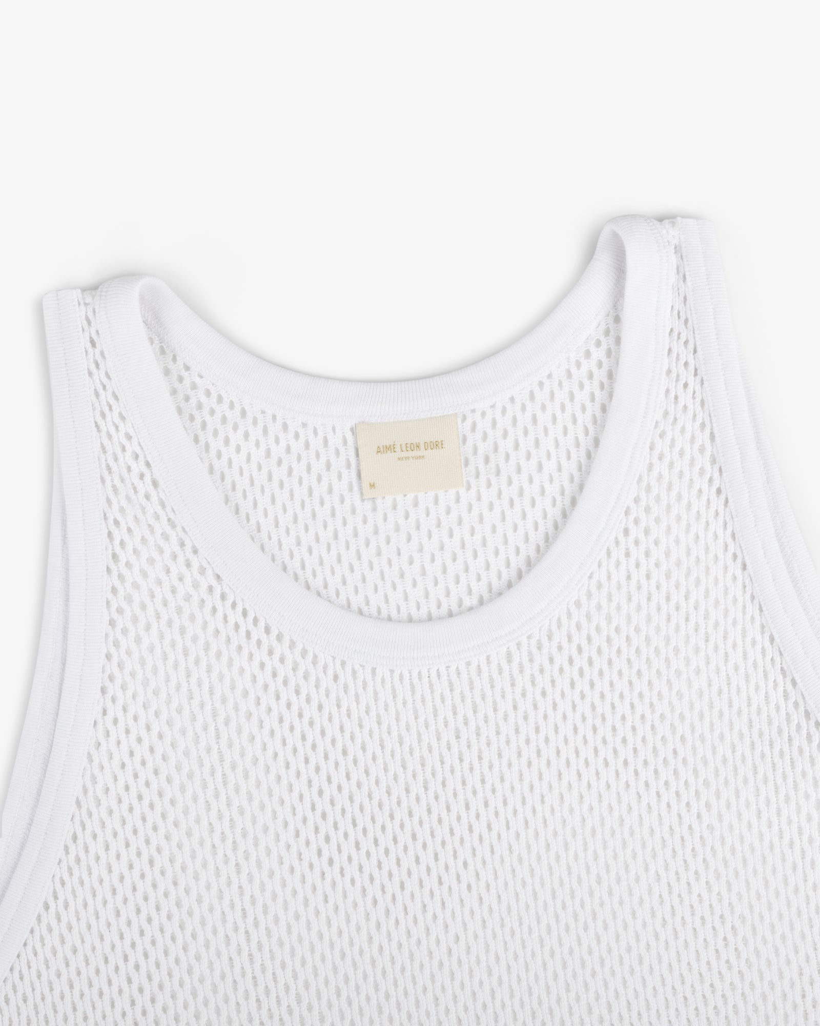 Mesh Tank Top featuring white mesh fabric, ribbed edges, and a beige neck label on a plain white background.