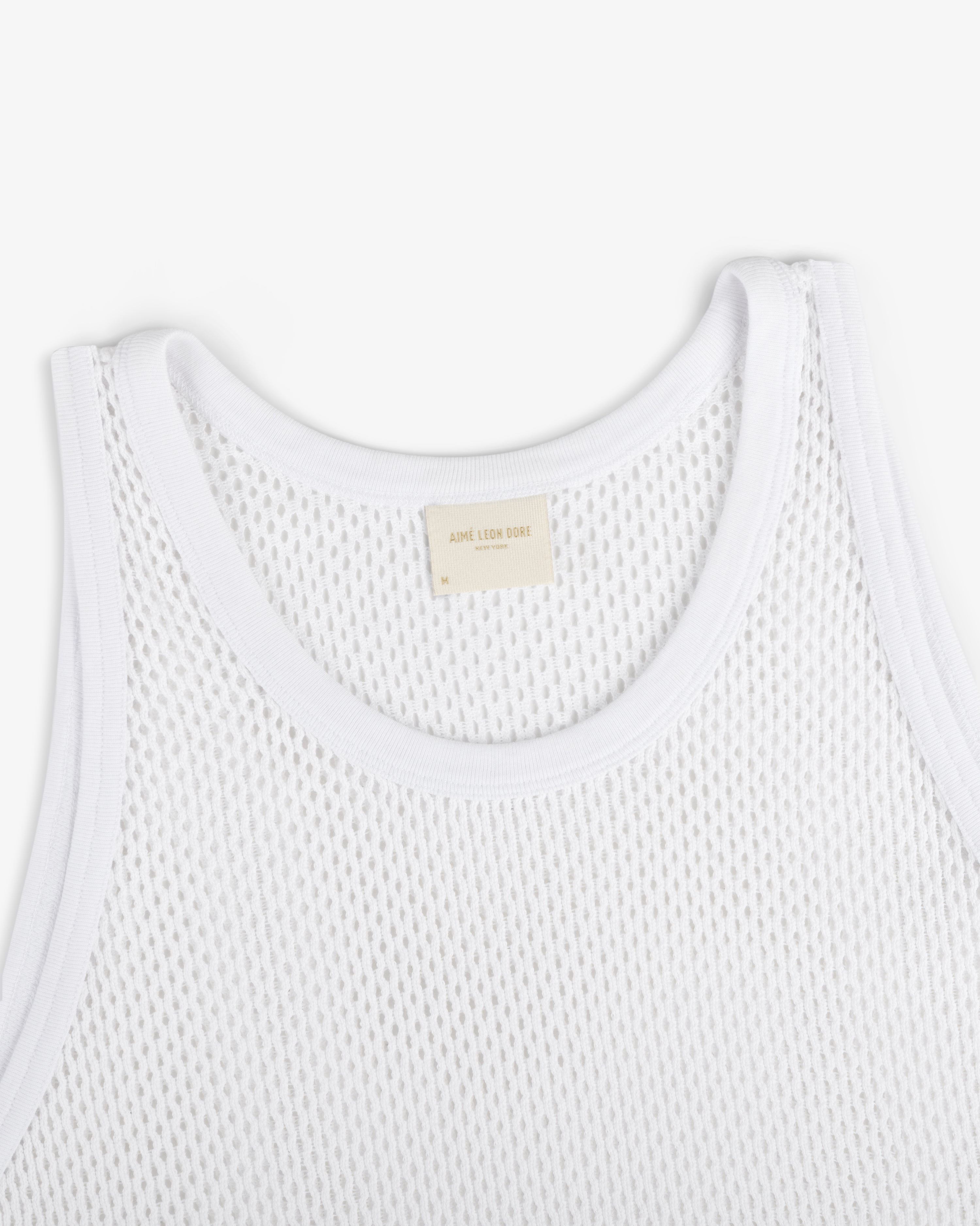 Mesh Tank Top featuring white mesh fabric, ribbed edges, and a beige neck label on a plain white background.