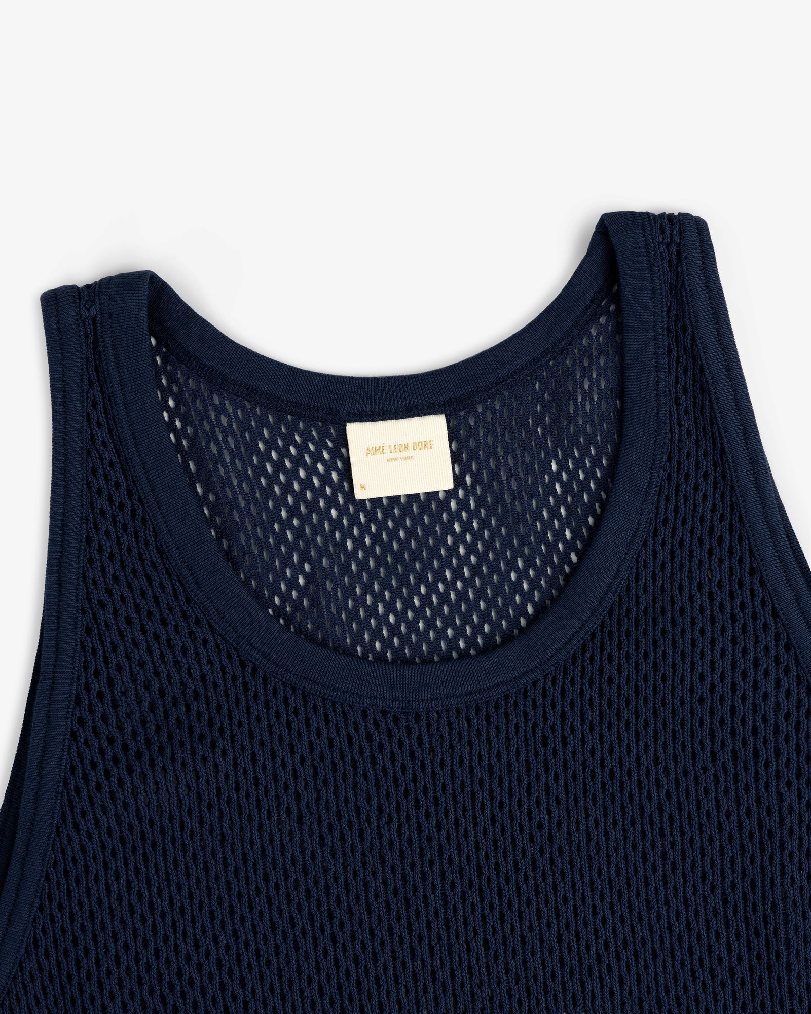 Mesh Tank Top in navy blue with a white neckline label, displayed flat on a white background.