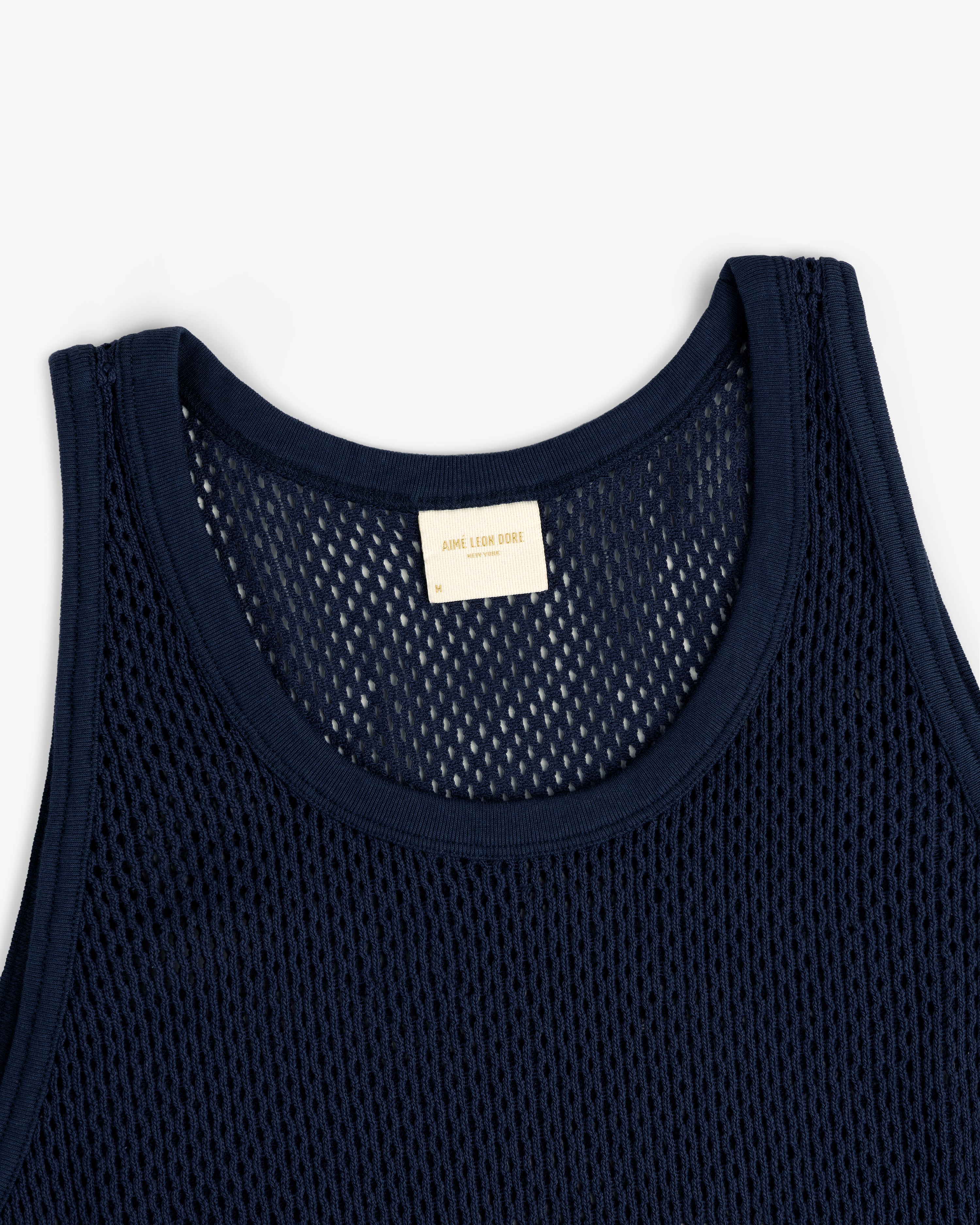Mesh Tank Top in navy blue with a white neckline label, displayed flat on a white background.