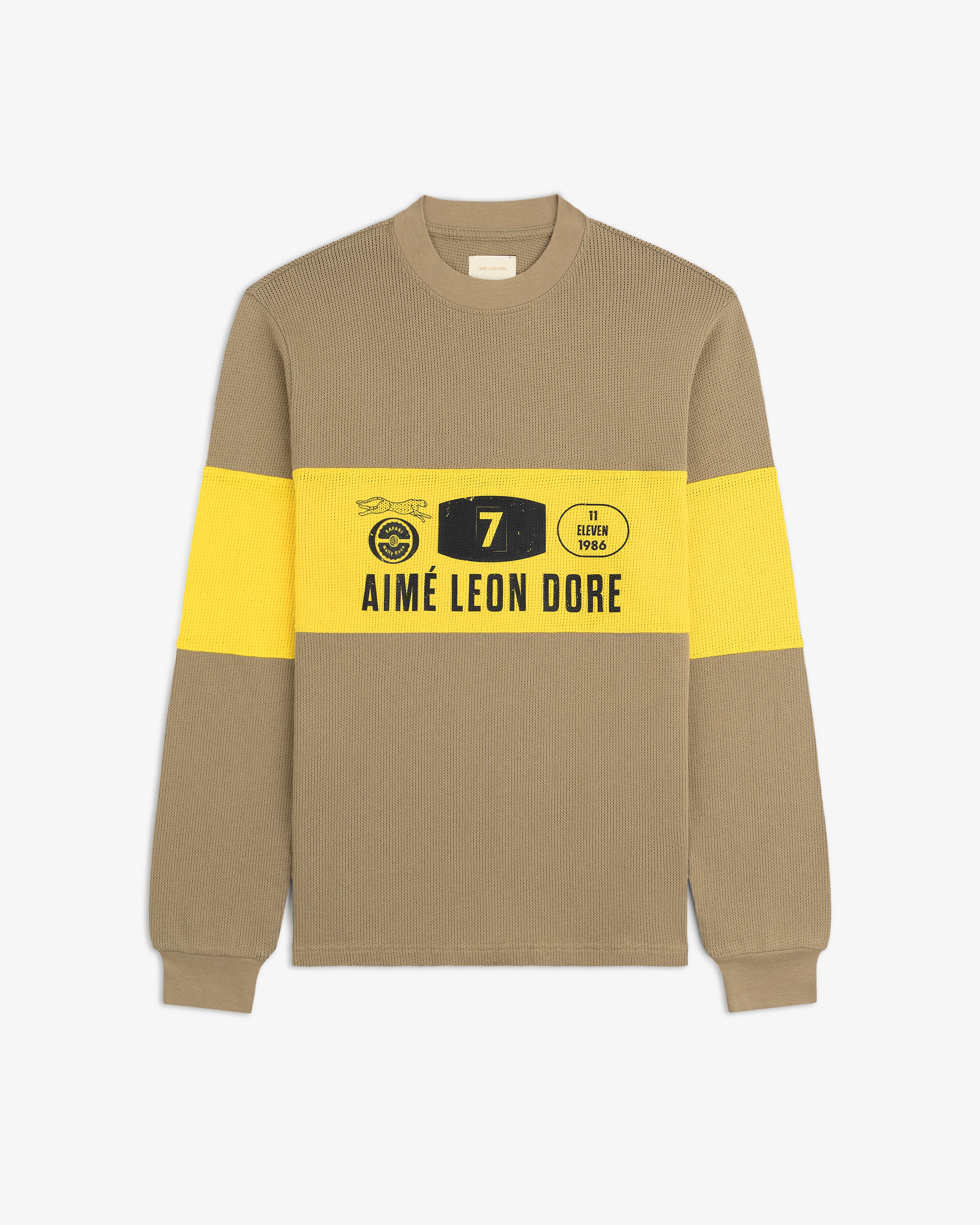 Beige and yellow Long-Sleeve Rally Tee with "AIMÉ LEON DORE" text and graphic prints on the front.