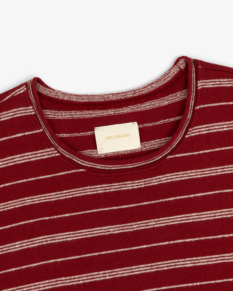 Jacquard Striped Rollneck Tee in red and white stripes with a beige collar label, shown on a white background.