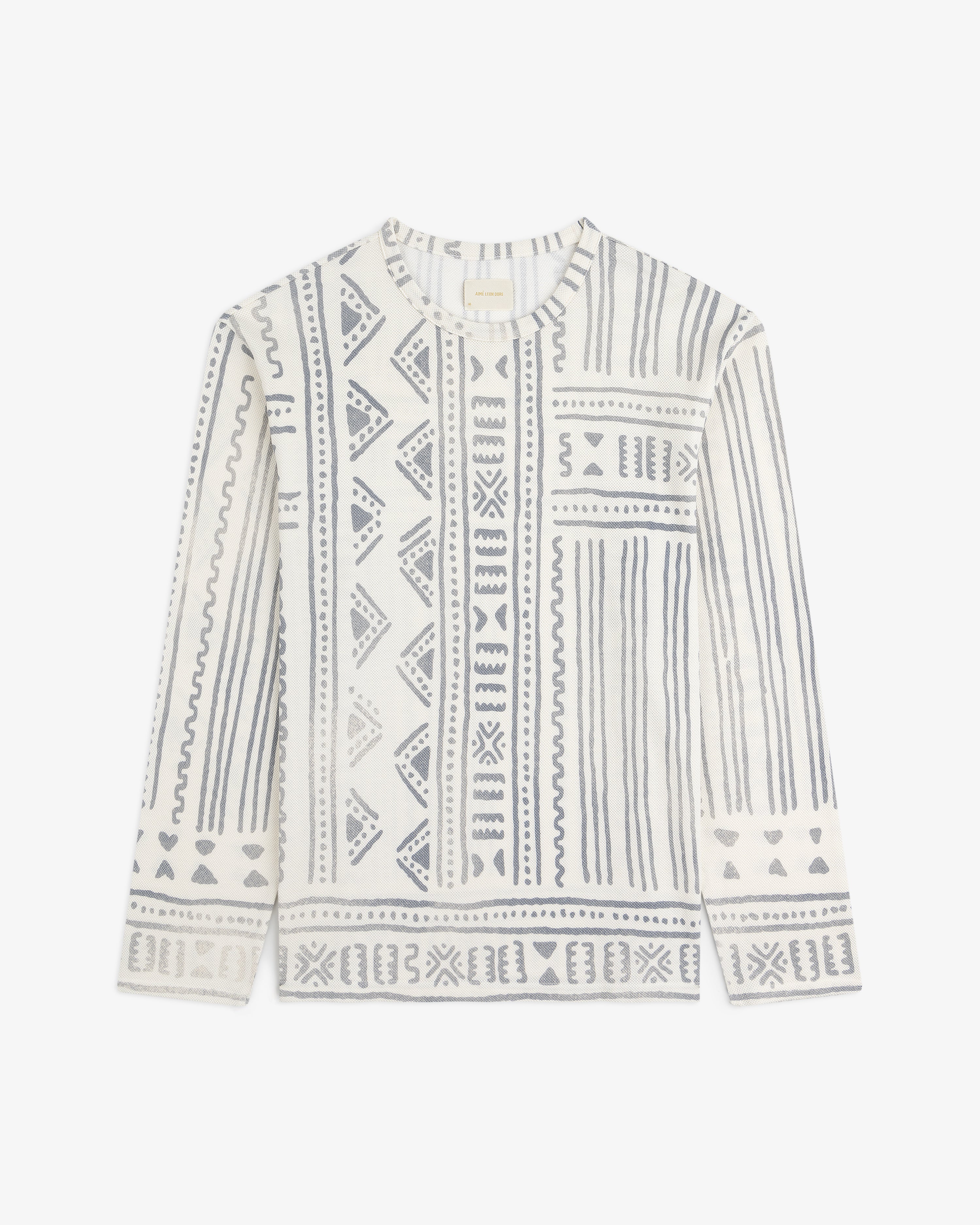 Long-Sleeve Mesh Tapestry Tee in white features blue geometric and tribal patterns in vertical and horizontal sections.