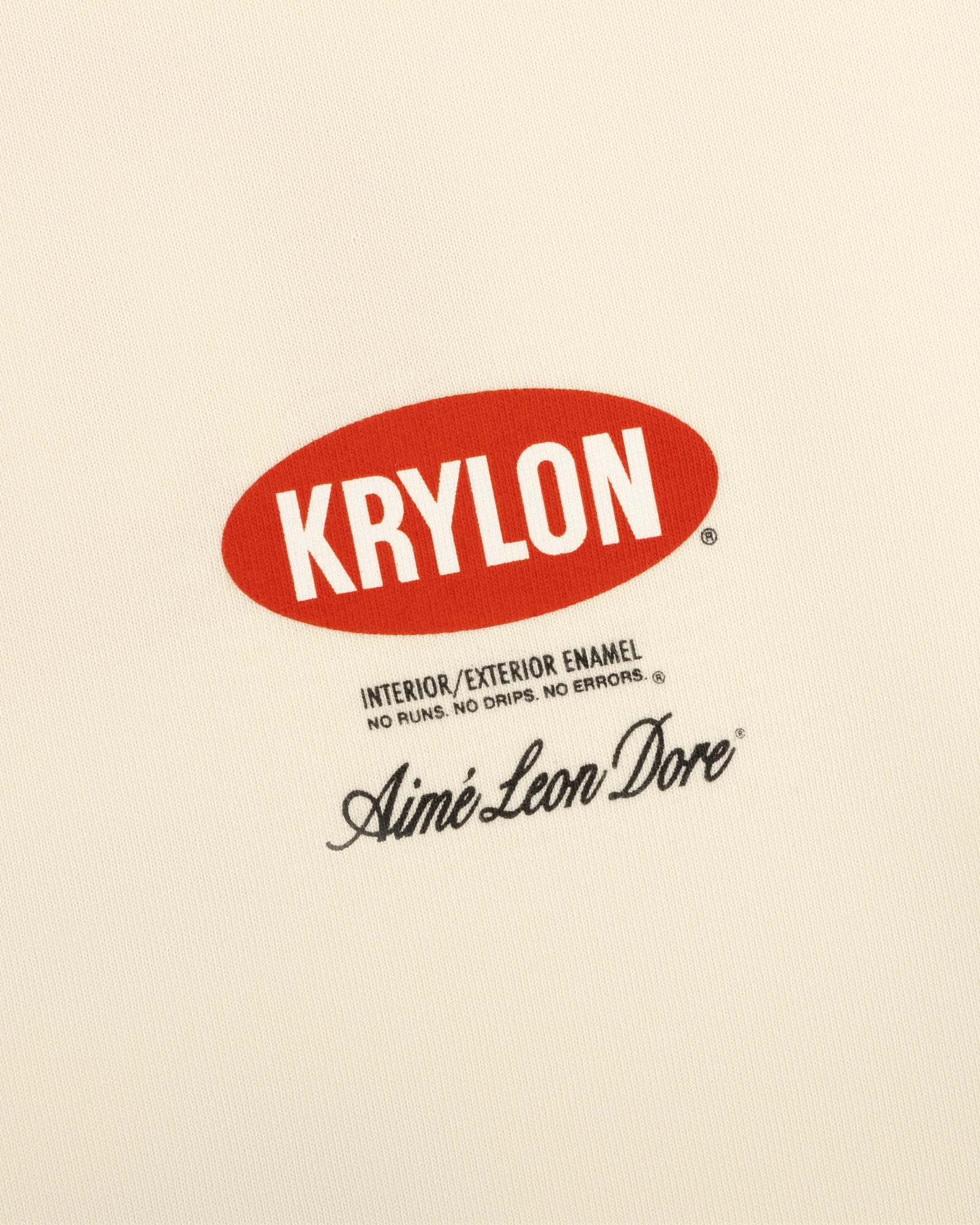Krylon Logo Tee features a red oval KRYLON logo above black text and Aimé Leon Dore signature on cream background.