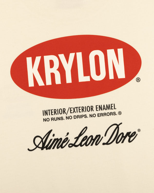 Krylon Logo Tee: Cream shirt featuring a red oval KRYLON logo with Aimé Leon Dore in black script below.