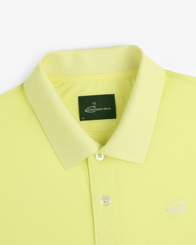 Lemon yellow ALD Golf Polo with a collar, two buttons, and a dark green Aimé Leon Dore neck tag.