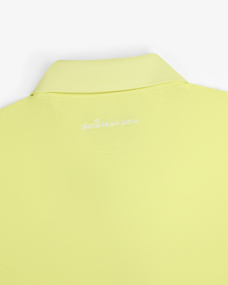 Close-up of the back collar of a light yellow ALD Golf Polo with "aimé leon dore" embroidered in white.