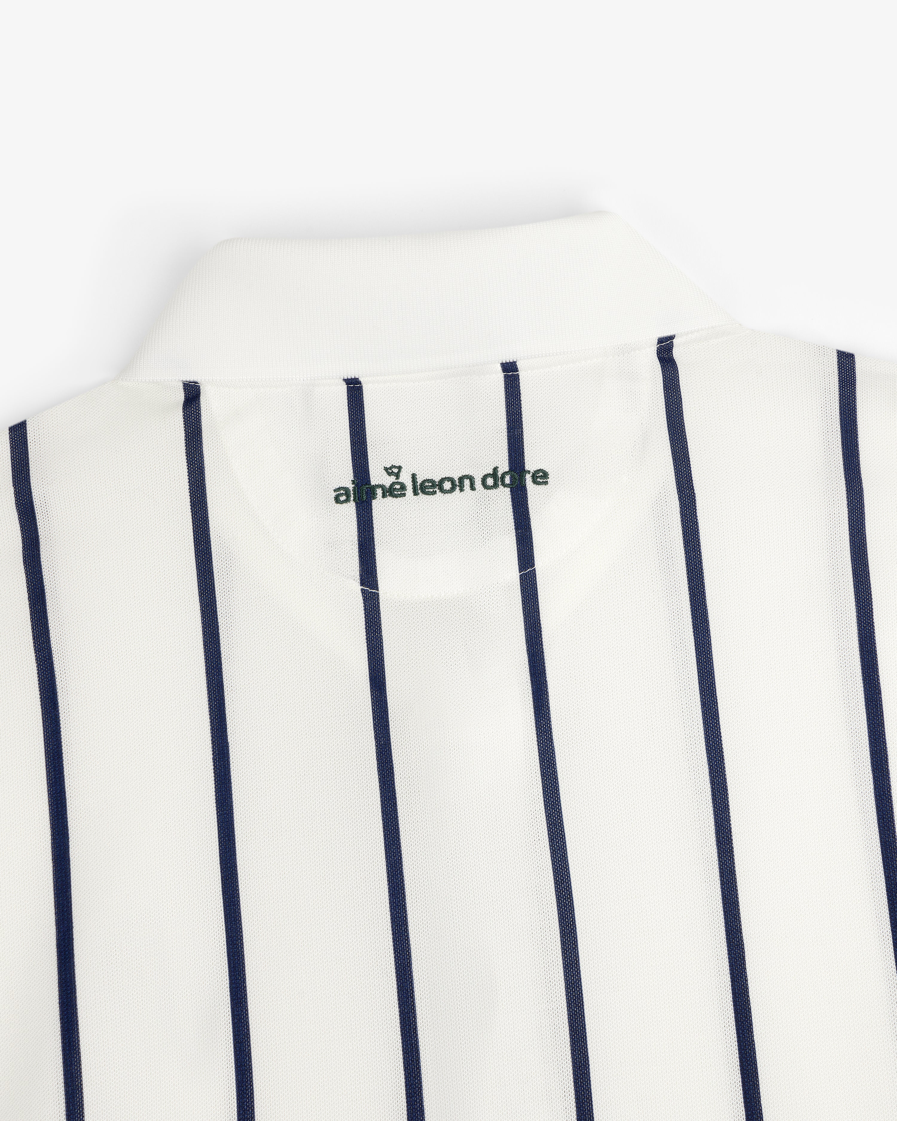 ALD Golf Polo: White collared shirt with vertical navy stripes and logo inside the neck.