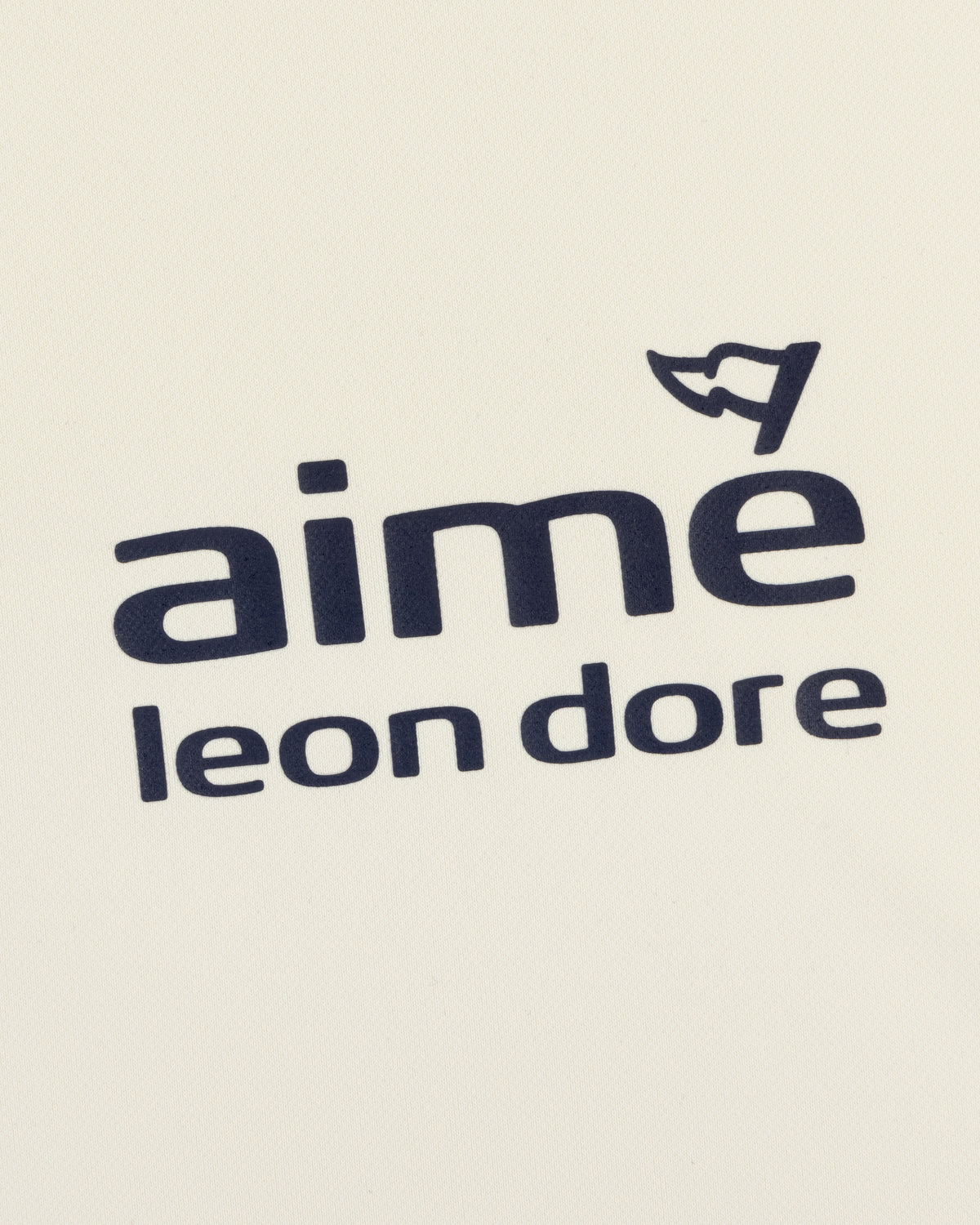 ALD Golf Tour Polo features "Aimé Leon Dore" in black on white, with a small cap graphic above the letter "e".