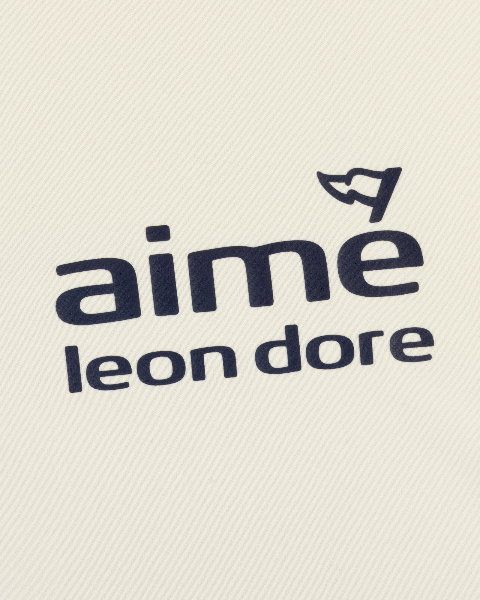 ALD Golf Tour Polo features "Aimé Leon Dore" in black on white, with a small cap graphic above the letter "e".