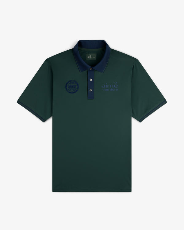 ALD Golf Tour Polo in dark green with a navy collar and subtle logos on both the left and right chest.