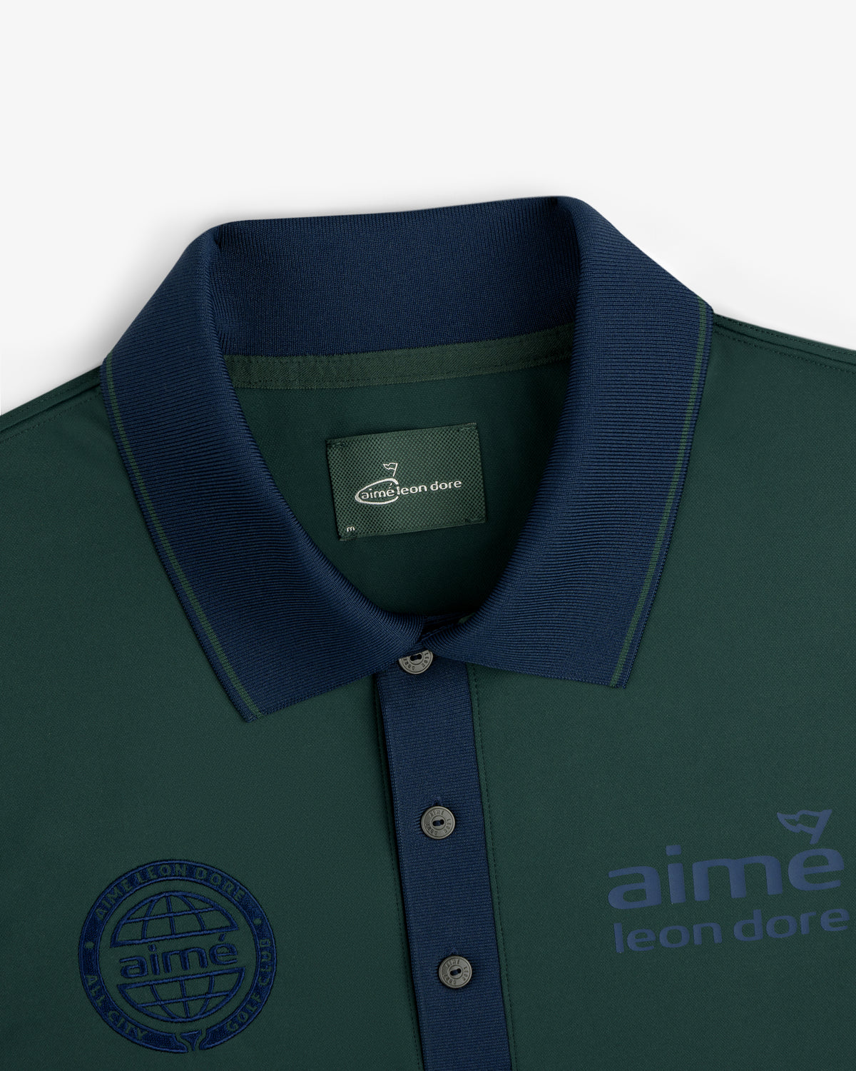 ALD Golf Tour Polo in dark green with navy collar, navy buttons, and aime leon dore logo on the chest.